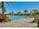 The community pool features multiple cabanas, palm trees, and lounge chairs at 1047 Timbervale Trl, Clermont, FL 34715