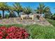 Stone monument sign for Esplanade at Wiregrass Ranch with lush landscaping and palm trees, welcoming residents and visitors at 1047 Timbervale Trl, Clermont, FL 34715