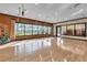 Bright fitness center with hardwood floors and large windows overlooking the pool area at 1047 Timbervale Trl, Clermont, FL 34715