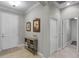Inviting foyer with neutral walls, tile flooring, stylish console table, and artwork creating a welcoming atmosphere at 1047 Timbervale Trl, Clermont, FL 34715