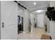 Spacious foyer with archway, barn door, and tiled floor, showcasing the home's open layout and decorative details at 1047 Timbervale Trl, Clermont, FL 34715