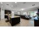 Open layout kitchen with island seating and stainless steel appliances; living and dining areas provide ample gathering spaces at 1047 Timbervale Trl, Clermont, FL 34715