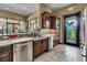 Kitchen with dark cabinetry, stainless steel appliances, and a view of the outdoor patio at 1047 Timbervale Trl, Clermont, FL 34715