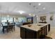 Open-concept kitchen with island seating, seamlessly flowing into the living and dining areas for easy entertaining at 1047 Timbervale Trl, Clermont, FL 34715