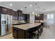 Gourmet kitchen with a large island, granite countertops, stainless steel appliances, and dark cabinetry at 1047 Timbervale Trl, Clermont, FL 34715