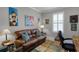 Comfortable living room, with a window for natural light, and a leather couch at 1047 Timbervale Trl, Clermont, FL 34715