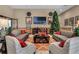 Lounge area decorated for the holidays, featuring comfortable seating and a large TV at 1047 Timbervale Trl, Clermont, FL 34715