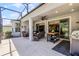 Enclosed patio with a ceiling fan and plenty of seating to enjoy the weather at 1047 Timbervale Trl, Clermont, FL 34715