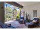 The screened patio has comfortable outdoor seating and decor at 1047 Timbervale Trl, Clermont, FL 34715