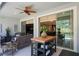 This patio features an outdoor dining table, ceiling fan and overlooks the interior through sliding glass doors at 1047 Timbervale Trl, Clermont, FL 34715