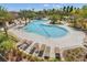 Inviting community pool area surrounded by lush landscaping and lounge chairs at 1047 Timbervale Trl, Clermont, FL 34715