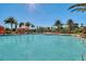Beautiful community pool with clear water and palm trees and lots of seating at 1047 Timbervale Trl, Clermont, FL 34715