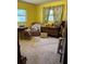 Bedroom featuring yellow walls, carpeted floors, and lots of natural light at 10517 52Nd Ct, Belleview, FL 34420
