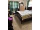Spacious bedroom featuring a queen sized bed, carpeted floors, and lots of natural light at 10517 52Nd Ct, Belleview, FL 34420