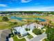 A beautiful aerial view of a home overlooking a golf course, complete with a serene lake and lush greenery at 11780 Se 178Th St, Summerfield, FL 34491