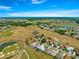 Scenic aerial view of the home with a golf course in the neighborhood and a sparkling water feature at 11780 Se 178Th St, Summerfield, FL 34491