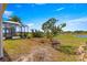 The backyard of the property boasts a screen enclosed lanai and picturesque views of a lush green lawn and serene pond at 11780 Se 178Th St, Summerfield, FL 34491
