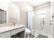 Updated bathroom featuring a spacious shower with pebble flooring, modern fixtures, and a marble countertop at 11780 Se 178Th St, Summerfield, FL 34491