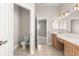 Well-lit bathroom with double sinks, white countertops and tile flooring at 11780 Se 178Th St, Summerfield, FL 34491