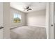 Spacious bedroom with neutral carpet, ceiling fan, and a large window at 11780 Se 178Th St, Summerfield, FL 34491