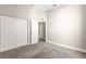 A carpeted bedroom provides ample storage with a large closet and access to the rest of the home at 11780 Se 178Th St, Summerfield, FL 34491