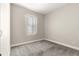Neutral bedroom offers a bright and serene ambiance with carpeted floors and a window with light-filtering blinds at 11780 Se 178Th St, Summerfield, FL 34491