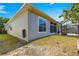 The rear exterior of the home, with a screen enclosed porch, complemented by well-maintained landscaping on a sunny day at 11780 Se 178Th St, Summerfield, FL 34491
