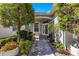 Charming front entrance featuring a well-manicured lawn, mature trees, and tasteful landscaping at 11780 Se 178Th St, Summerfield, FL 34491