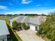 Charming home exterior with lush landscaping, a well-maintained lawn, and a two car garage at 11780 Se 178Th St, Summerfield, FL 34491