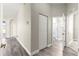 A long hallway featuring wood-look flooring, leading to the bathroom, bedrooms, and other areas of the home at 11780 Se 178Th St, Summerfield, FL 34491