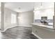 Spacious kitchen with stainless appliances, granite countertops, and gray wood flooring at 11780 Se 178Th St, Summerfield, FL 34491