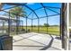 A large screened lanai with concrete flooring overlooking the golf course at 11780 Se 178Th St, Summerfield, FL 34491