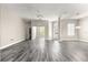 Open concept living room showcasing modern gray wood floors and bright, neutral paint at 11780 Se 178Th St, Summerfield, FL 34491