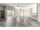 Spacious living room with modern gray wood floors and lots of natural light at 11780 Se 178Th St, Summerfield, FL 34491