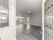 Welcoming view of the living area with gray wood-look floors and access to a sliding door to the lanai at 11780 Se 178Th St, Summerfield, FL 34491