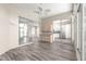 Sunroom with gray wood flooring and large sliding windows for views at 11780 Se 178Th St, Summerfield, FL 34491