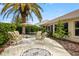 Backyard patio with a charming seating area and lush greenery, ideal for outdoor entertaining and relaxation at 1222 Camero Dr, The Villages, FL 32159