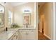 Well-lit bathroom showcasing a double vanity with granite countertops and modern fixtures at 1222 Camero Dr, The Villages, FL 32159