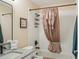 Cozy full bathroom with granite vanity and decorative shower curtain at 1222 Camero Dr, The Villages, FL 32159