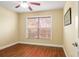 Bright bedroom with wood-look floors and a large window at 1222 Camero Dr, The Villages, FL 32159