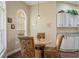 Cozy breakfast nook with a round table, upholstered chairs, and a window offering plenty of natural light at 1222 Camero Dr, The Villages, FL 32159