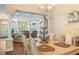 Dining area offers a view into the open kitchen with barstool seating, perfect for entertaining at 1222 Camero Dr, The Villages, FL 32159