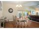 Elegant dining room with a chandelier, wood floors, and direct access to the kitchen at 1222 Camero Dr, The Villages, FL 32159