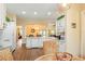 Bright kitchen featuring white cabinetry, granite countertops, and a breakfast bar area at 1222 Camero Dr, The Villages, FL 32159