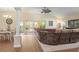 Open living area with plush sofa, neutral décor, and sliding glass doors to the outdoor area at 1222 Camero Dr, The Villages, FL 32159