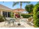 Outdoor patio with dining table, chairs, and umbrella, perfect for relaxing and entertaining at 1222 Camero Dr, The Villages, FL 32159