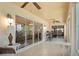 Bright and airy sunroom features tiled flooring and sliding glass doors, perfect for relaxing and enjoying the view at 1222 Camero Dr, The Villages, FL 32159