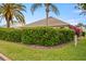 Lush green landscaping surrounds this home, providing privacy and curb appeal at 1222 Camero Dr, The Villages, FL 32159
