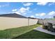 Spacious backyard with well-maintained lawn, privacy fence, and cozy fire pit area for outdoor enjoyment at 1251 Saranac Pl, The Villages, FL 32163