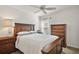 Comfortable bedroom featuring neutral color palette, wood furnishings, and sun-filled window at 1251 Saranac Pl, The Villages, FL 32163